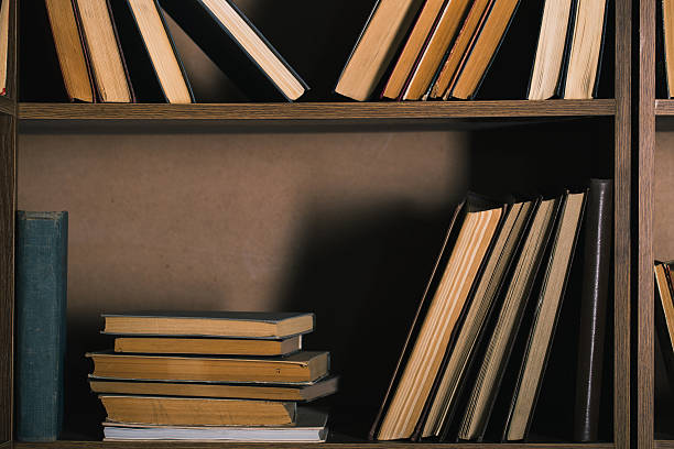 istock Old books on wooden shelf. 626501734