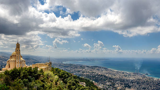 View of Harissa monastery with Beirut in the background The photo taken on a partially cloudy stormy day concentrates in the foreground on the Harissa monastery and depicts in the background the coastline of the city of Beirut. monastery photos stock pictures, royalty-free photos & images
