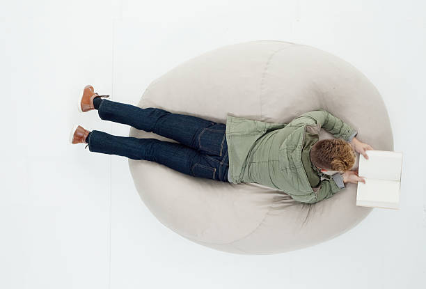 istock Above view of man reading book 626503228
