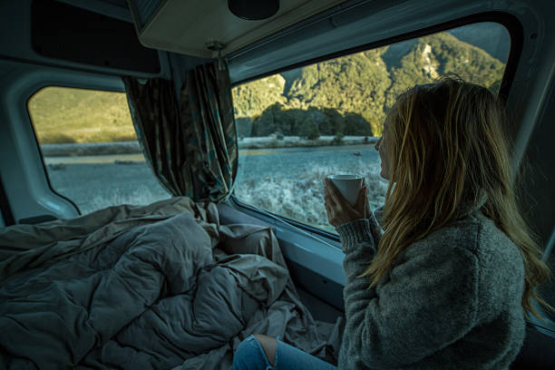 istock Young woman waking up in motor home 626503372