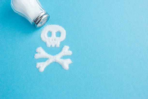 Symbol Skull and crossbones written salt. Salt kills. Crumbled salt on a blue background