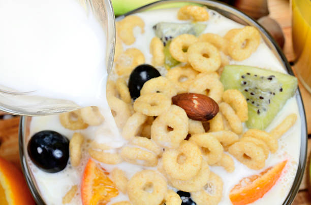 istock milk flow in bowl with cereal on table 626511756