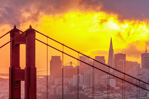 City skyline and Golden Gate bridge (San Francisco, California). Downtown and sunrise on the background. Canon 1Dx and telephoto lens.
