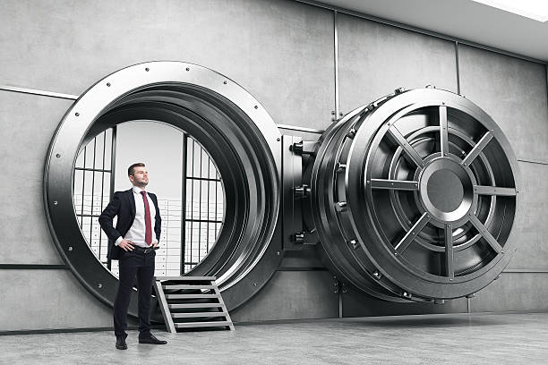istock Confident businessman near open vault door 626516802