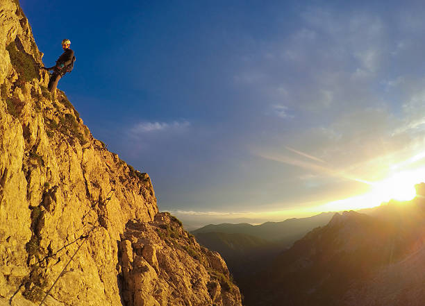 istock Aplinist Climbing the Mountain at Sunset 626523182