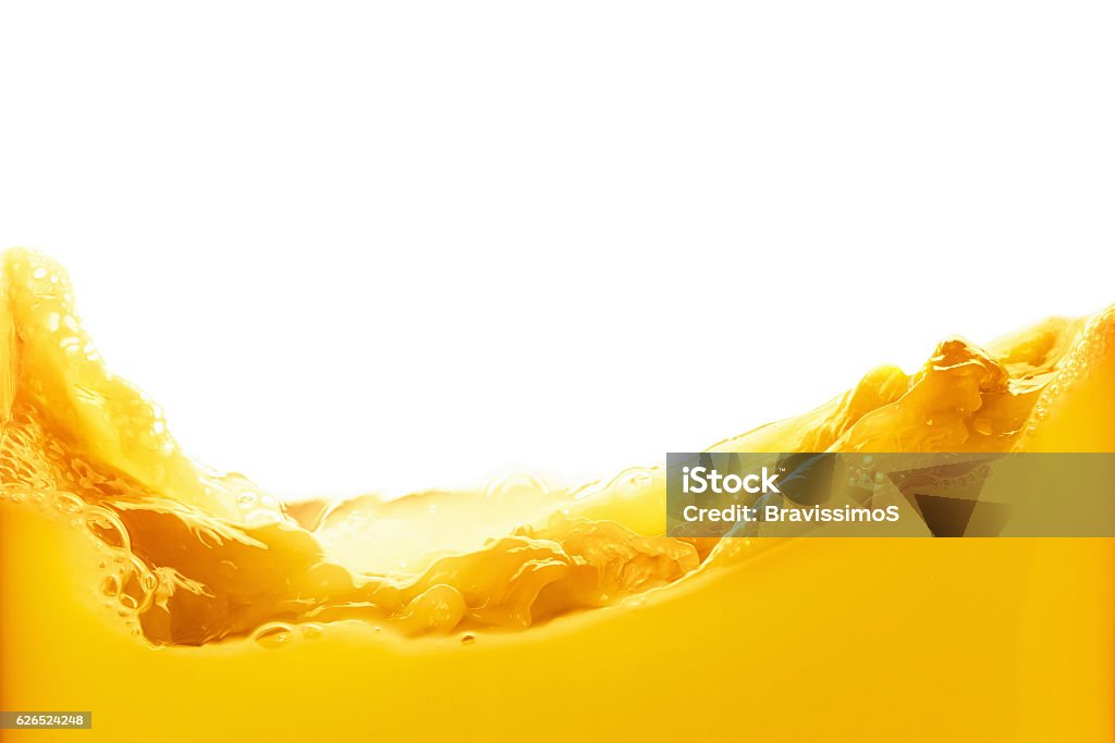 Orange juice splash isolated on white background Orange juice splash isolated on white background. Healthy fresh drink, wave with drop Juice - Drink Stock Photo