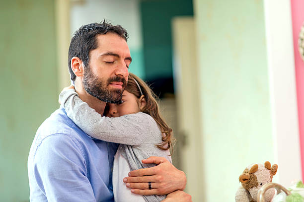 istock Ethnic father holding his daughter close on his lap 626530720