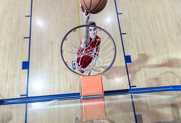 istock Young male basketball player attempting a dunk 626535684