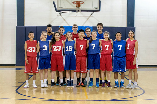 Diverse co-ed group of high school basketball players