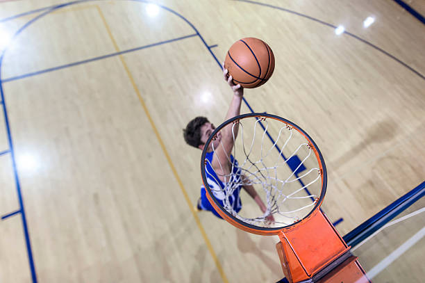istock Young male basketball player attempting a dunk 626535700