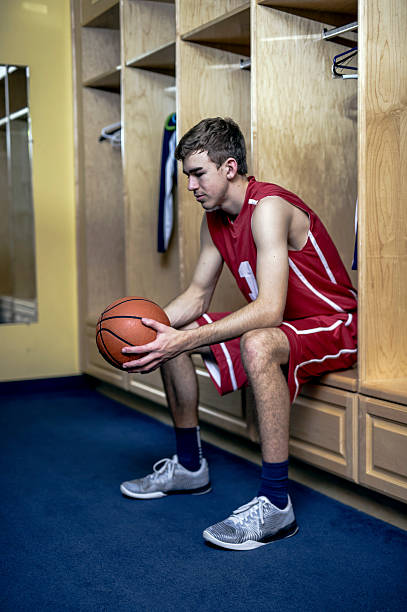 Male basketball star thinking deeply before the game starts