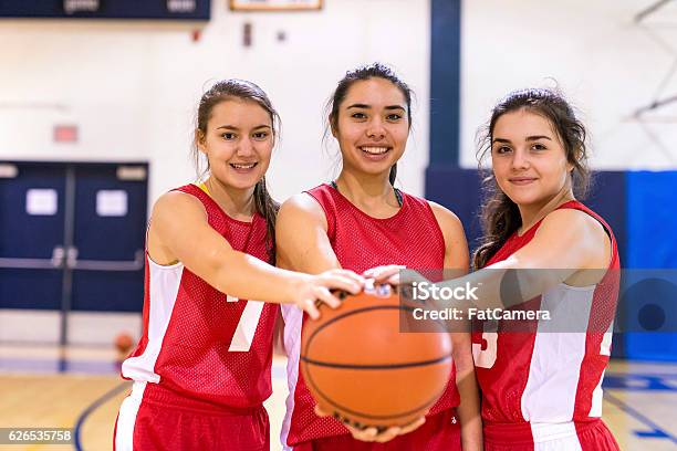 Diverse Group Of Female Basketball Players Holding A Basketball Stock Photo - Download Image Now