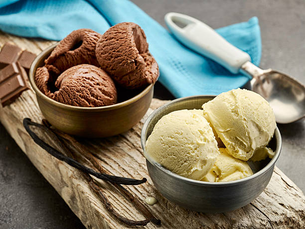 vanilla and chocolate ice cream vanilla and chocolate ice cream on wooden board scoop shape photos stock pictures, royalty-free photos & images