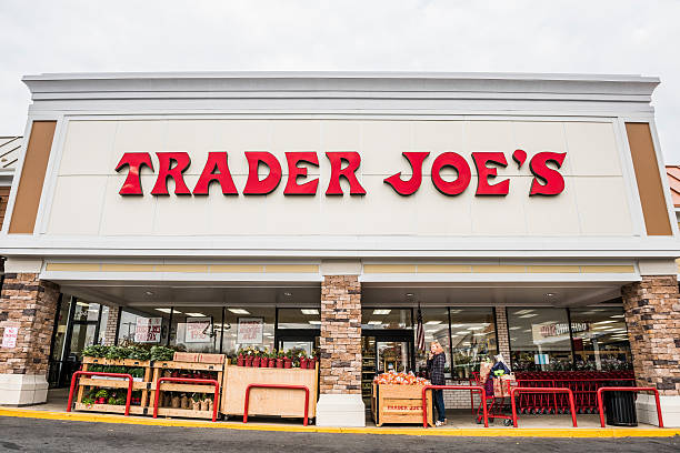 Trader Joes grocery store entrance with sign Fairfax, USA - November 25, 2016: Trader Joes grocery store facade with sign and items on display and people walking fairfax virginia photos stock pictures, royalty-free photos & images