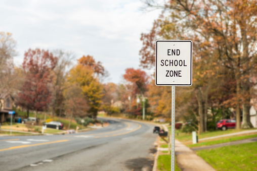 Public End School Zone sign on road