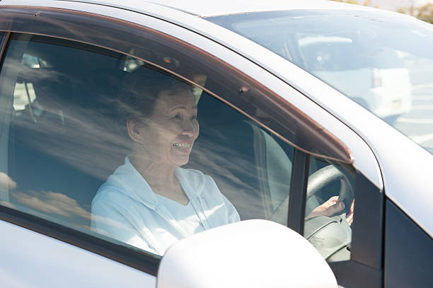 istock Elderly women who are driving a car 626539312