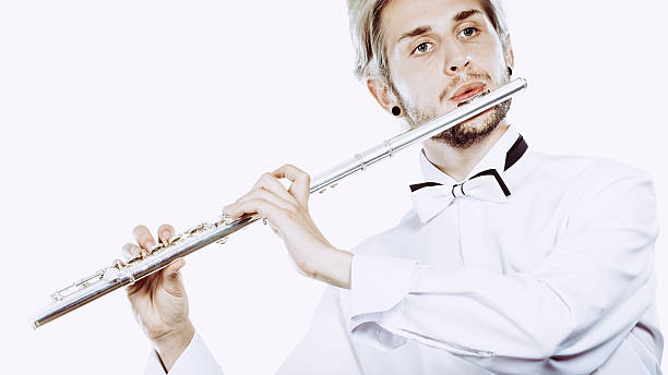 istock Male flutist playing his flute 626540396