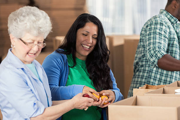 istock Diverse friends pack boxes during food drive 626541348