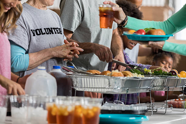 istock Volunteers serve healthy meal in soup kitchen 626541442