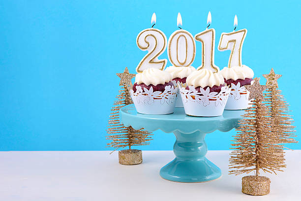 istock Happy New Year cupcakes with 2017 candles 626542908