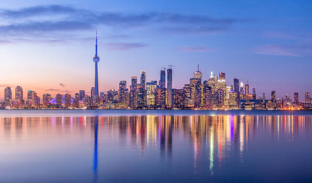 Toronto Skyline with purple light - Toronto, Ontario, Canada Toronto Skyline with purple light - Toronto, Ontario, Canada ontario canada photos stock pictures, royalty-free photos & images