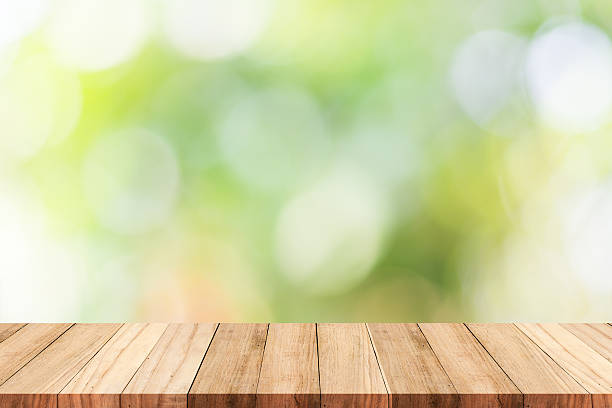 istock wooden table top on green background 626545756