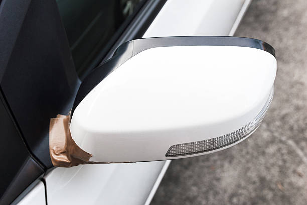Side mirror of white car broken. Side mirror of white car broken. Fix with adhesive tape. broken side view mirror stock pictures, royalty-free photos & images