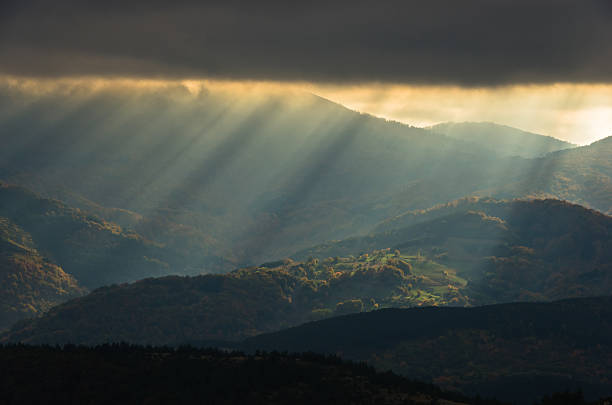 istock Heavy overcast sky with sunrays over meadows and picturesque forests 626548264