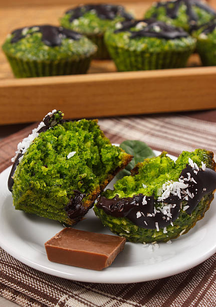 Fresh muffins with spinach, desiccated coconut and chocolate glaze