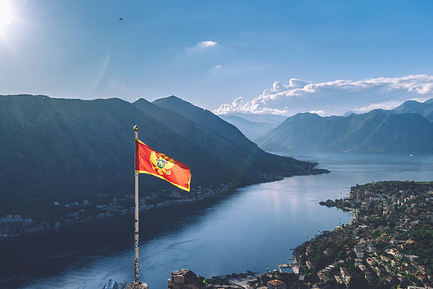 montenegro flag over kotor bay in montenegro - karadağ bayrağı stok fotoğraflar ve resimler