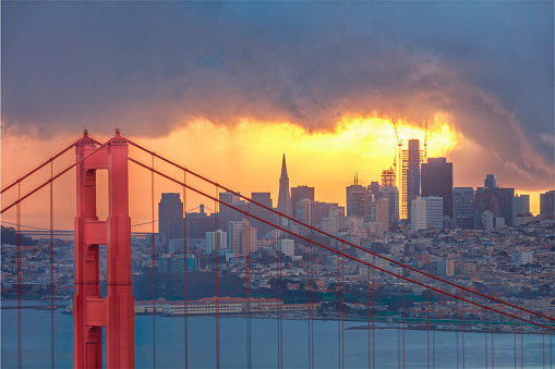 City skyline and Golden Gate bridge (San Francisco, California). Downtown and sunrise on the background. Canon 1Dx and telephoto lens.