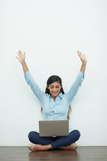 istock Joyful Young Woman Working on Laptop on Floor 626565946