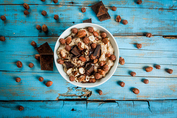 nourishing and delicious breakfast, oatmeal with hazelnuts - yoghurt chocolate bowl bildbanksfoton och bilder