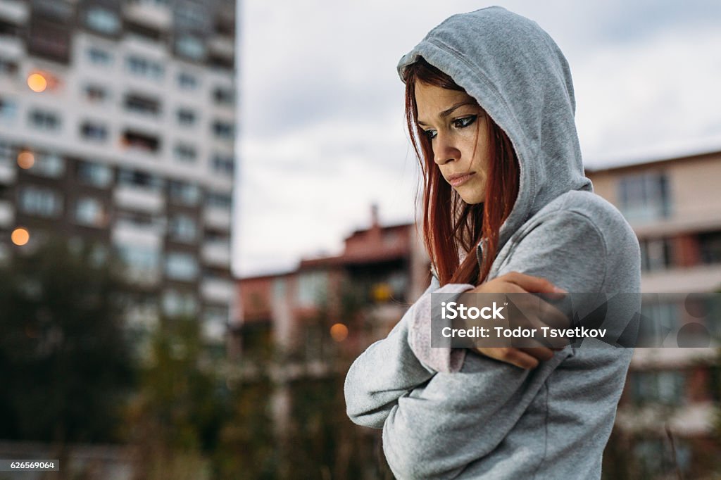 Teen Problems Sad girl standing alone outdoors. Teenager Stock Photo