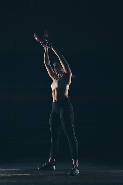 Strong woman lift kettlebell on a gym stock photo