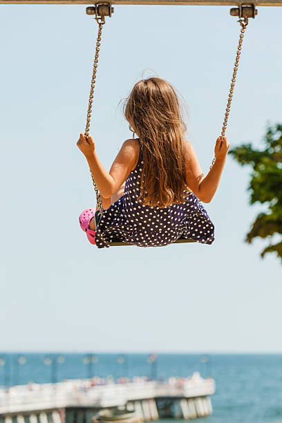 istock Girl swinging on swing-set. 626570074