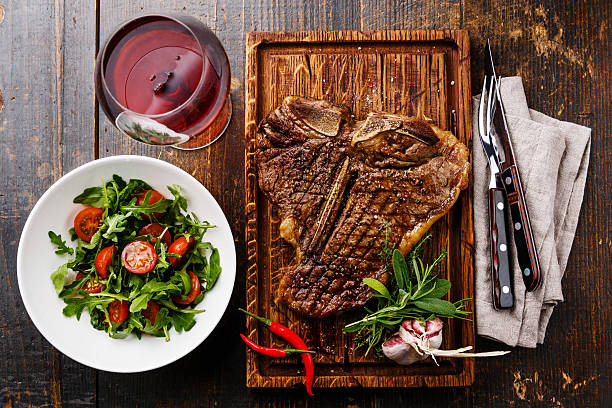 istock Grilled T-Bone Steak with Salad and wine 626570720