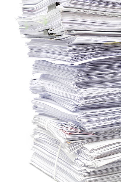 istock Stack of business papers isolated on white background 626571754