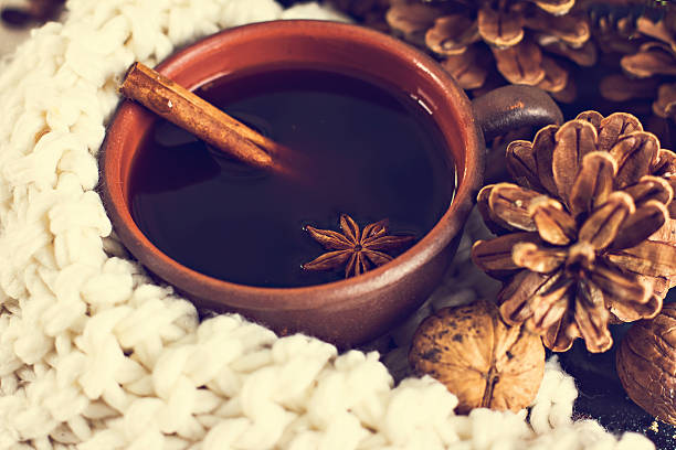 Coffee, nuts, cones, cozy knitted blanket.