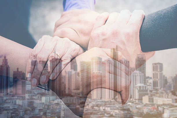 istock Double exposure of three hands collaboration of teamwork and city 626572936