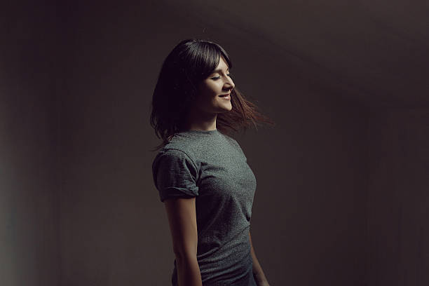 istock Pretty brunette woman posing in dark room 626575458