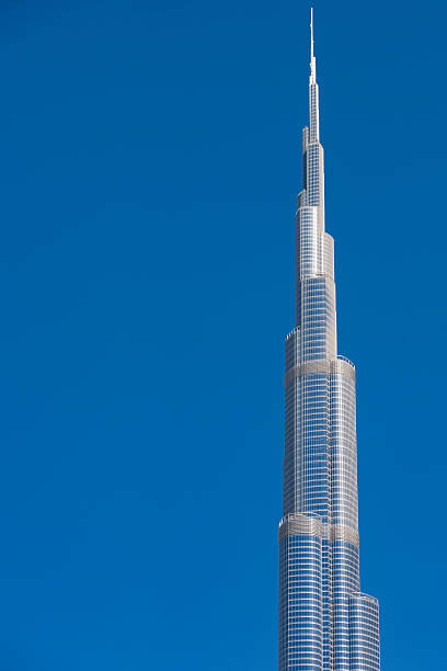 Dubai, UAE - March 4, 2012: The Burj Khalifa or Burj Dubai skyscraper building isolated against clear blue sky on a sunny day. At 828 meters, the Burj Khalifa, formerly known as the Burj Dubai, currently holds the record for tallest building and tallest manmade structure in the world. The building was designed by Adrian Smith, at the time working at Skidmore, Owings & Merrill. The construction started in 2004 and was completed in December 2009.