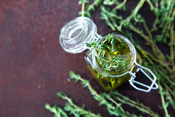 istock Thyme oil. Thyme essential oil jar glass bottle 626583248