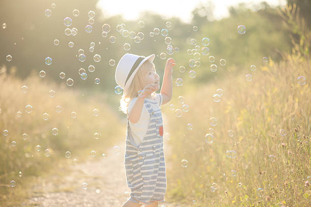 istock Little boy and soap bubbles 626584360