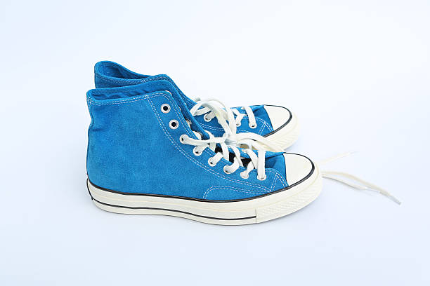 istock Pair of new blue sneakers isolated on white background 626586524