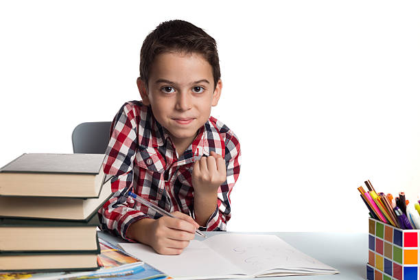 istock Happy schoolboy after doing his homework 626587752