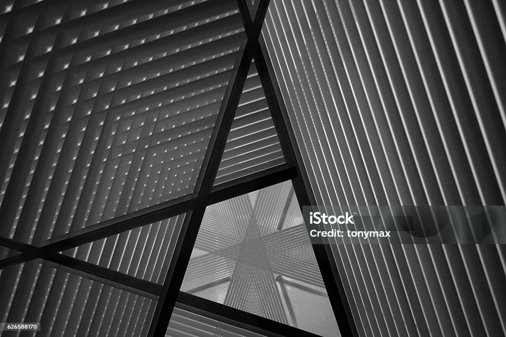 Reworked photo of sloped walls. Realistic though unreal industrial interior. Reworked close-up photo of sloped walls / pitched roof / ceiling. Realistic though unreal industrial interior. Abstract black and white modern architecture background image. Architecture Stock Photo