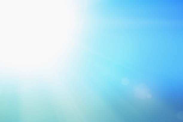 A perfect sunny summer's day with blazing noon sun  which could, however, casue dangerous sunburn and heat stroke.Lens flare from the sun. Suitable as background for science, nature, vacations, etc.