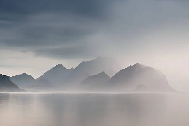 Summer cloudy Lofoten islands. Norway misty sea and fjords. Nordic rain.