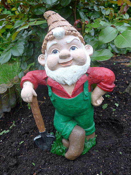 istock Garden gnome with shovel at work 626592272